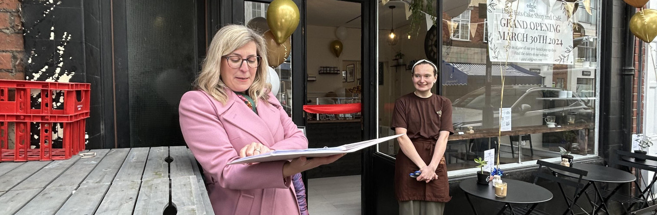 A celebrant talking at a cafe opening