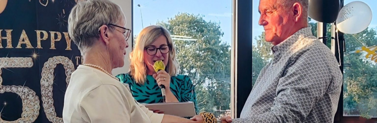 A man and woman holding hands facing each other