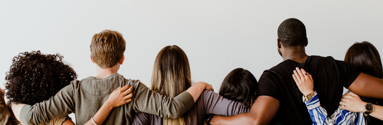 A group of people with their arms around each other