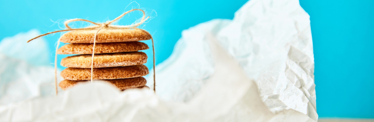A bunch of cookies wrapped in white paper on a table