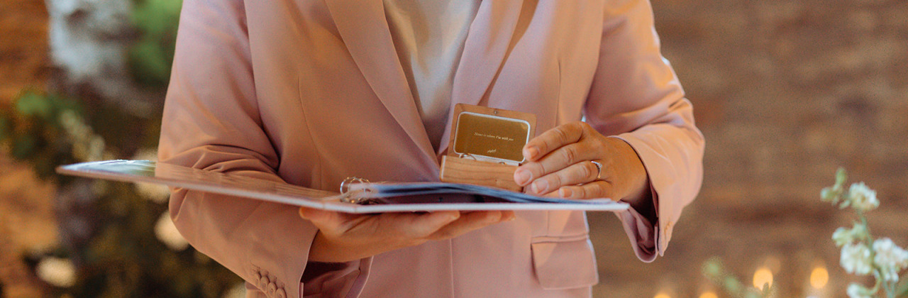 A woman holding a wedding ring box