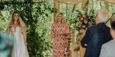 Sam White stood in a marquee speaking holding her folder 