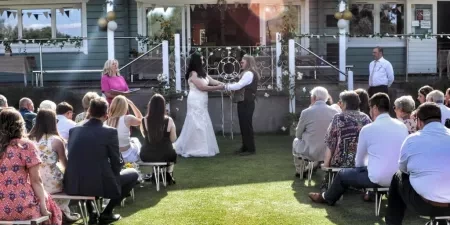 A man and woman taking part in a hand fasting cerfemony