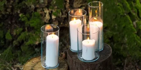 Candles in a woodland on logs