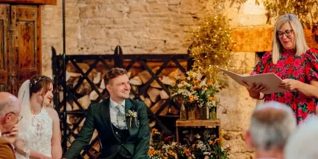 A photo of a bride and groom at their wedding ceremony with Sam White Celebrant at Cripps Barn.