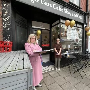 A celebrant talking at a cafe opening