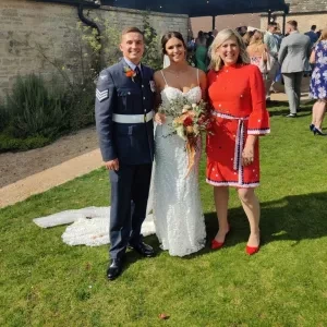 Sam White stood with and bride and groom