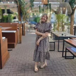 A woman stood with her hand on her arm