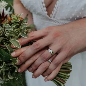 A photo of a couple with their wedding rings and the bouquet at Noah's Pond in Somerset.